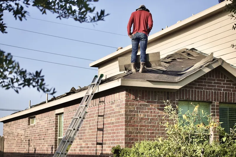 Professional roofer working on a residential roof in East Goshen